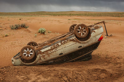 Upside down subaru flipped off road in the dangerous desert of utah