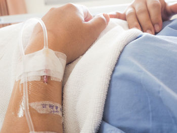 Midsection of woman lying on floor
