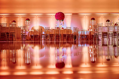 Reflection of chairs and table arranged at table on floor in restaurant