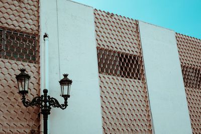 Low angle view of street light against building