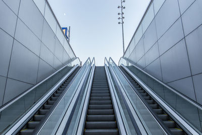 Low angle view of escalator against sky