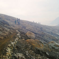 High angle view of people on landscape against sky