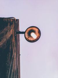 Low angle view of rusty metal against clear sky