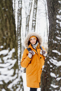 Portrait of woman standing in snow