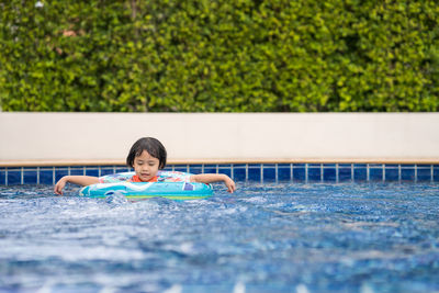 Little adorable girl have fun at outdoor swimming pool