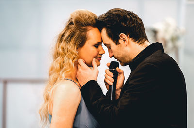 Side view of young couple kissing