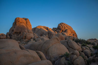 Rock formations against clear blue sky