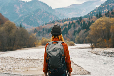 Rear view of man looking at mountains