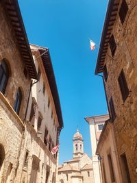 Low angle view of buildings against blue sky