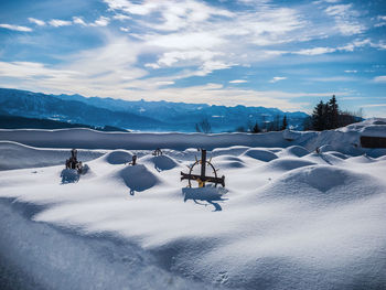 Scenic view of snow covered field against sky