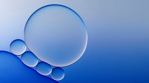 Close-up of bubbles against blue background