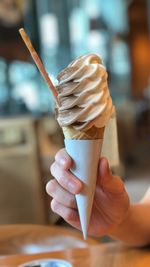 Close-up of hand holding ice cream cone