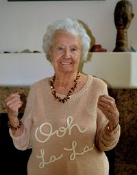 Portrait of smiling woman with arms raised