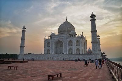 Tourists in front of historical taj mahal 