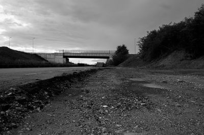 Empty road against cloudy sky