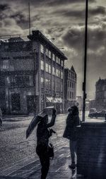 People walking on street in city during rainy season