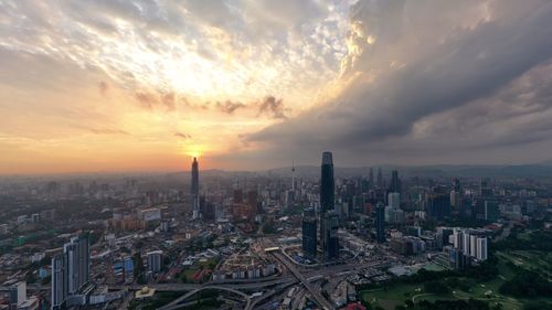 Aerial view of buildings against sky during sunset