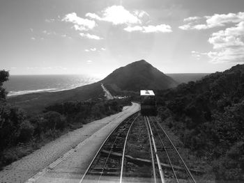 Railway tracks on mountain against sky