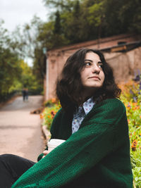 Young woman sitting outdoors