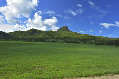 Scenic view of golf course against sky