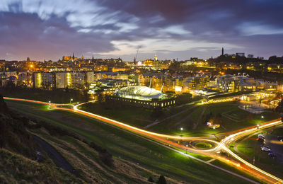 High angle view of illuminated city street and buildings at night