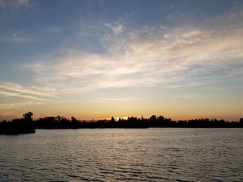 Scenic view of lake against sky during sunset