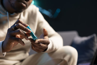 Midsection of woman using mobile phone