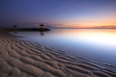 Scenic view of beach against sky during sunset