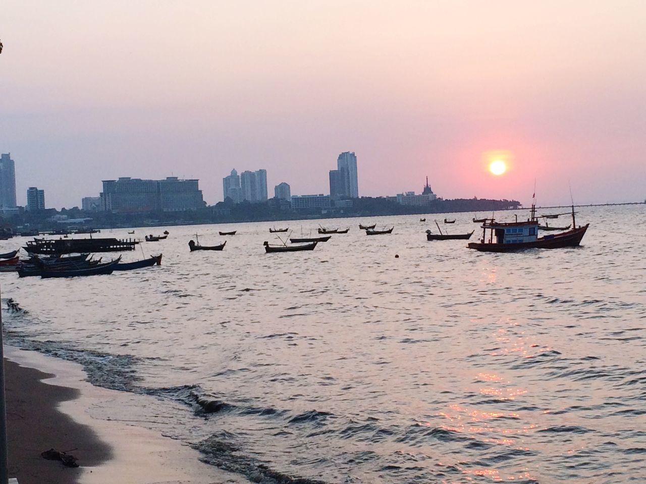 sunset, water, nautical vessel, transportation, sea, boat, mode of transport, waterfront, sun, building exterior, moored, architecture, built structure, orange color, sky, scenics, city, beauty in nature, tranquil scene, nature