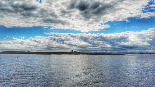 Scenic view of sea against cloudy sky