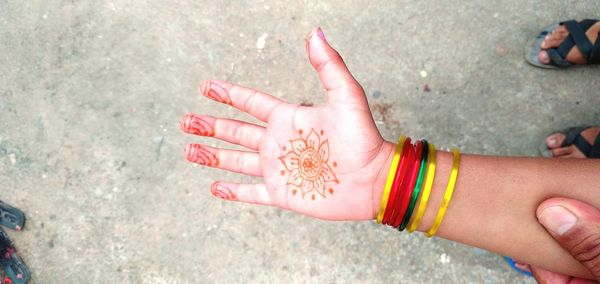 High angle view of woman hand with tattoo