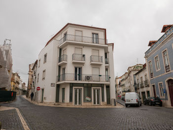 Street amidst buildings in city against sky