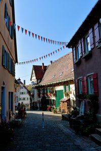 Street amidst buildings in city against sky