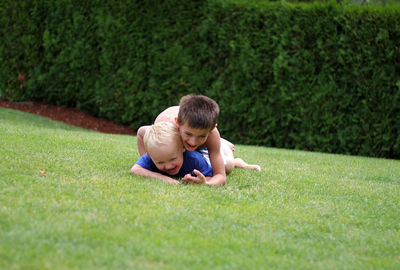 Happy brothers playing at lawn