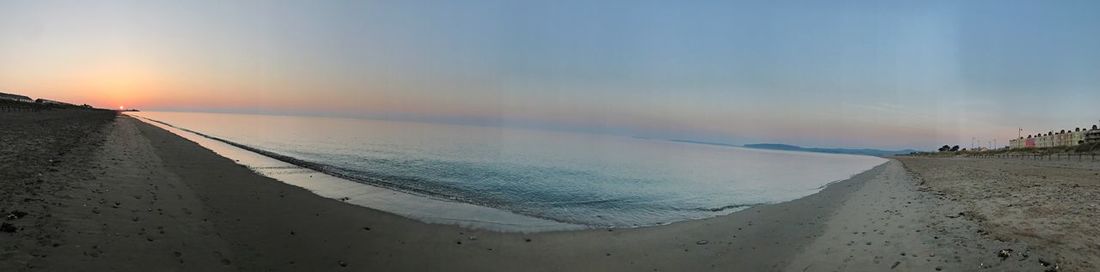 Panoramic view of beach against sky during sunset