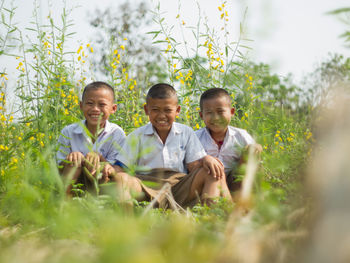 Boy standing on grassy field