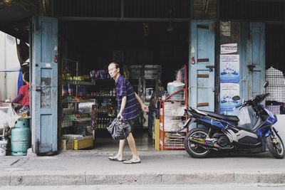Man standing on sidewalk