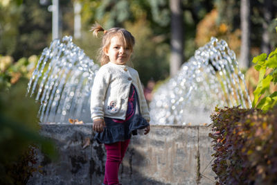 Full length of girl standing in water