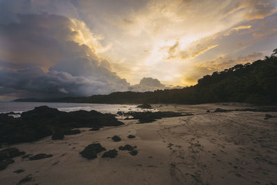 Scenic view of beach against sky during sunset