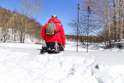 Rear view of man on snow field