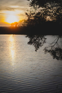 Scenic view of lake against sky during sunset