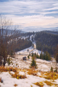 Scenic view of snow covered land against sky