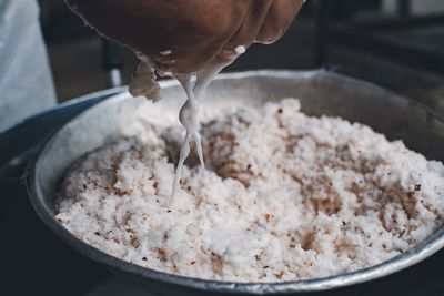 Cropped hand preparing food at home