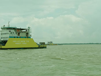 Ship sailing in sea against sky