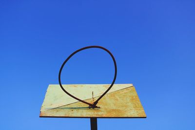 Low angle view of umbrella against clear blue sky