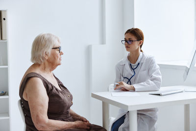 Woman sitting on table