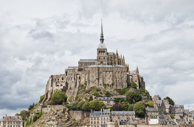 Low angle view of historical building against cloudy sky