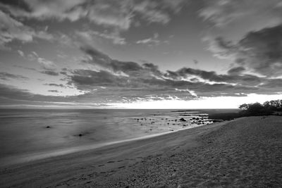 Scenic view of beach against sky during sunset