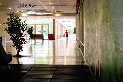 Rear view of man in corridor