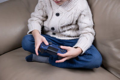 Midsection of woman holding suitcase